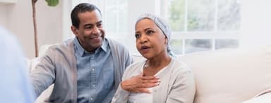 Elderly woman touches her chest to describe symptoms