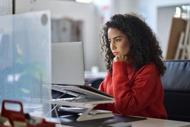Woman researching personal loan options on a computer.