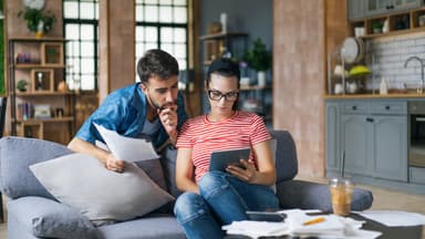 Couple explores HELOC options on a tablet.