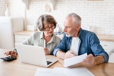 Adult couple reviewing finances and bill collection notices