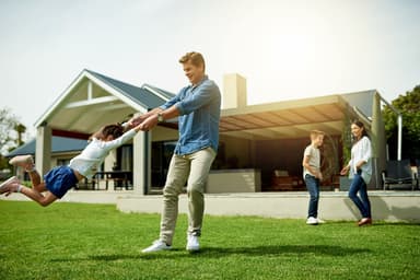 Family plays on lawn.