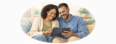 Couple sitting on the coach looking over finances