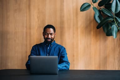 Man researches personal loans on a laptop.