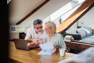 Couple uses a laptop for personal finances.