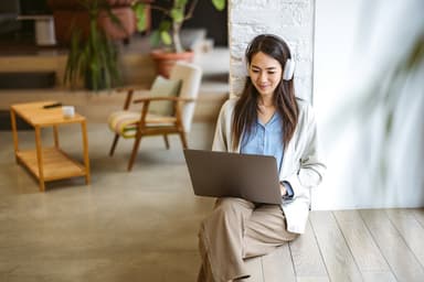 Woman researches personal loan options on a laptop.