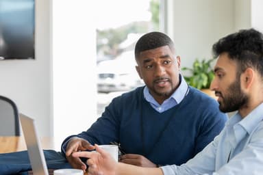 Two people discuss options to deal with debt.