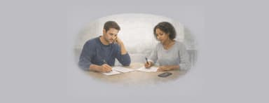 Two adults reviewing notes at a table before a phone call.